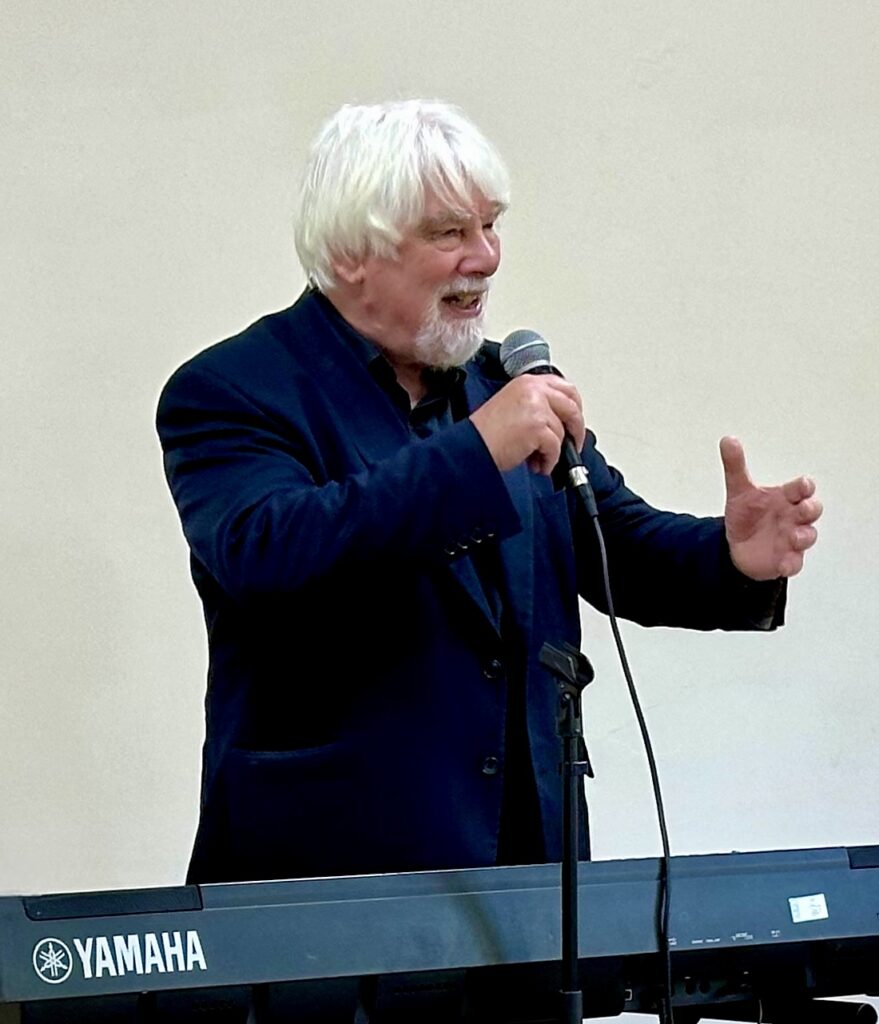 man at keyboard with mic